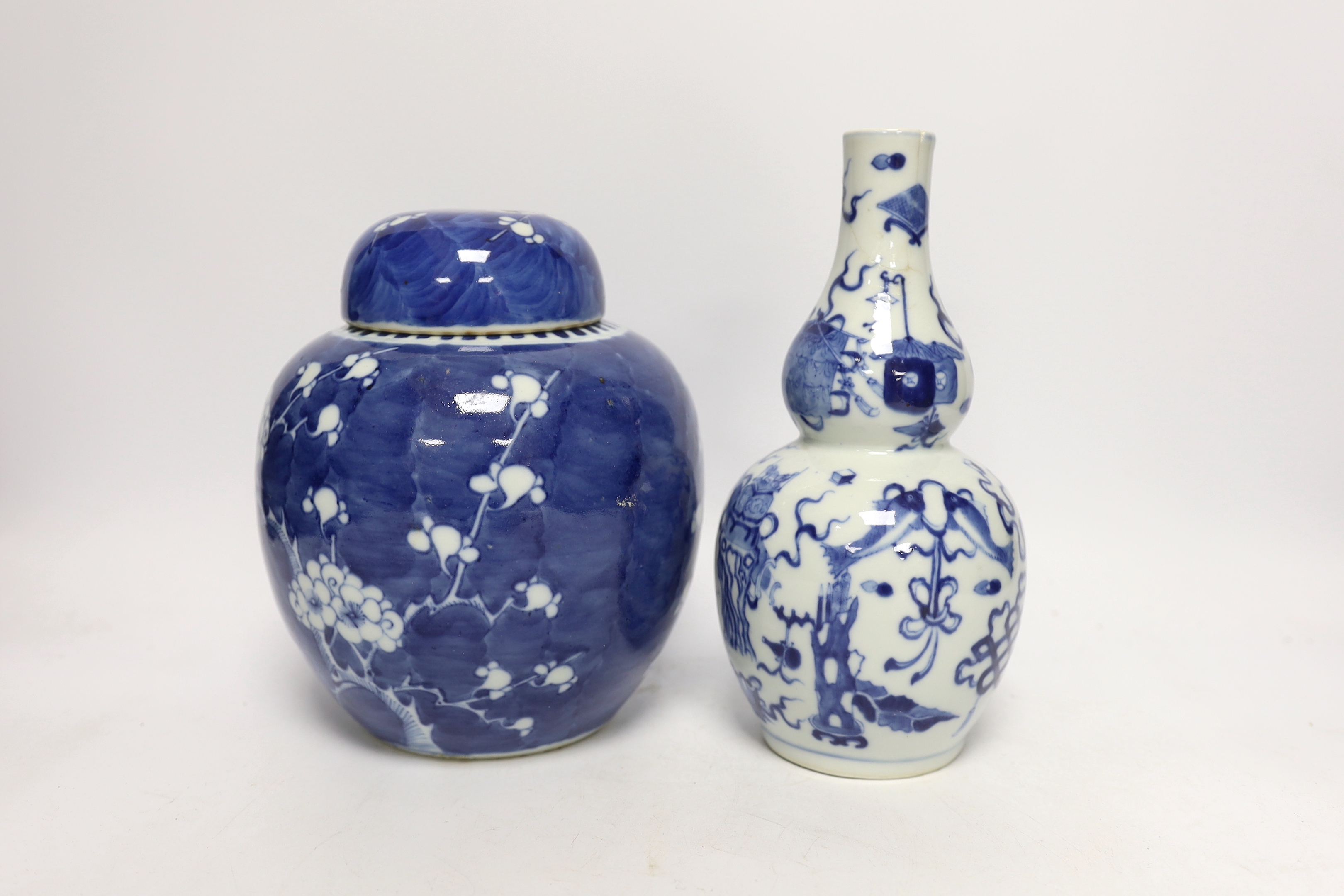 A Chinese blue and white prunus jar and cover and a double gourd vase, late 19th/early20th century, tallest 23cm